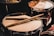 pair of brown wooden drumsticks on top of white and gray musical drum