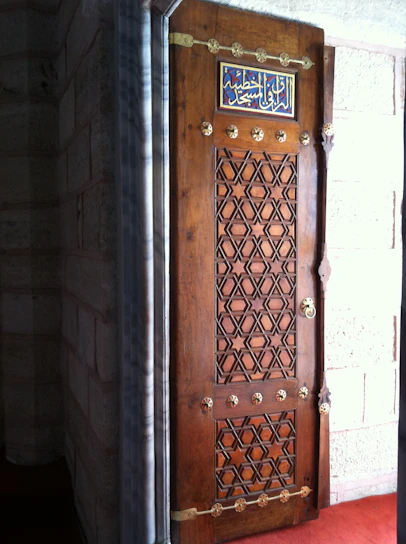 A beautifully crafted wooden door with intricate carvings in a modern Riyadh home.