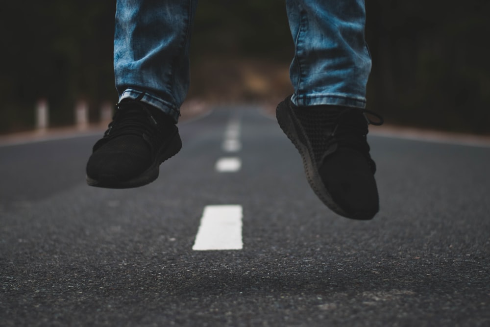 man jumping in the middle of the road