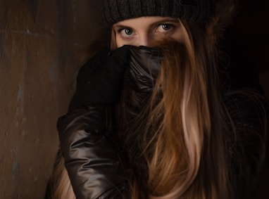 woman covering her face using jacket onlyfans