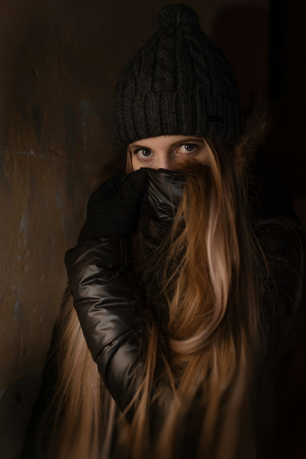 woman covering her face using jacket