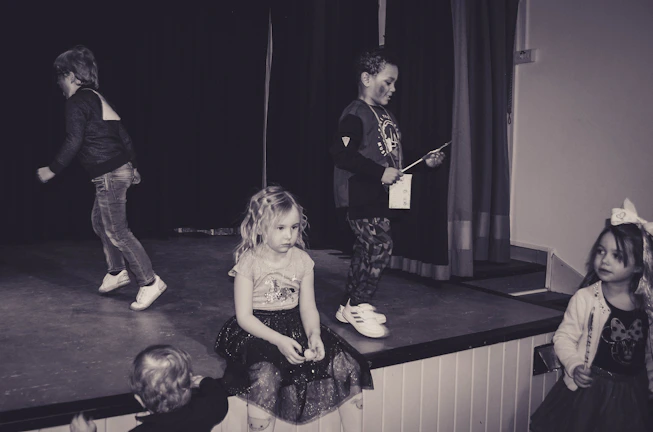School event with students and teachers celebrating achievements on stage
