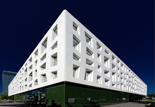 low-angle photography of white and green painted building in Risch-Rotkreuz Switzerland