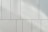 a white wall with a clock on the side of it