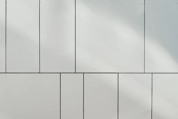 a white wall with a clock on the side of it