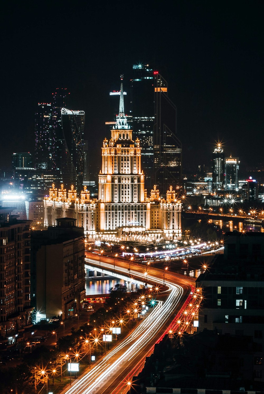 time-lapse photography of vehicles on city near buildings