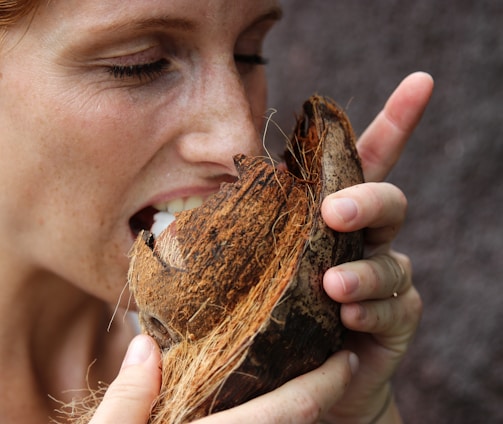 woman eating coconut meat