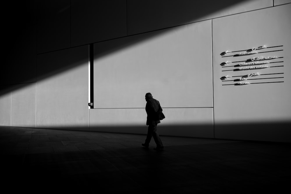 silhouette of man walking on pathway