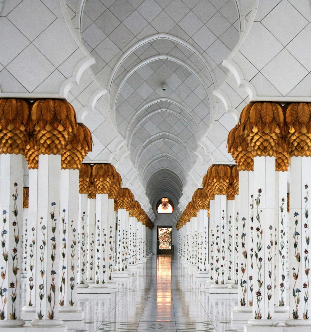photo of white columns and marble tiles