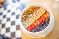 A family enjoying a healthy breakfast featuring bowls of superfood powders and dry fruits.