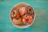 Close-up of assorted colorful donuts and pastries on a rustic wooden table.