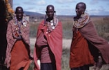 three women wearing capes outdoors