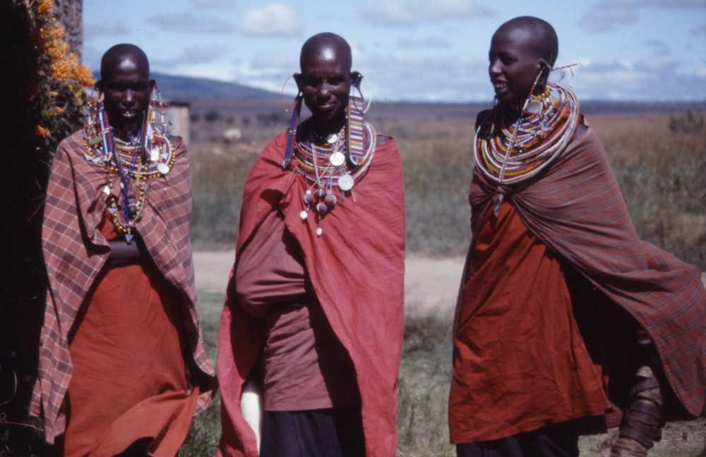 three women wearing capes outdoors