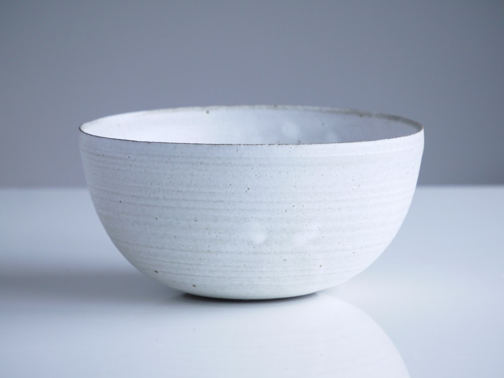 closeup photo of white bowl on white surface