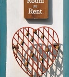 closeup photo of room for rent sign