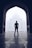silhouette photography of man standing near door in front of mosque