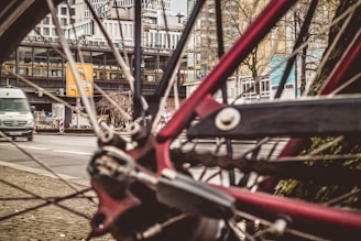 A close-up of a bicycle parked next to a public transport stop.