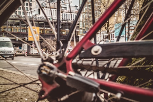 A close-up of a bicycle parked next to a public transport stop.