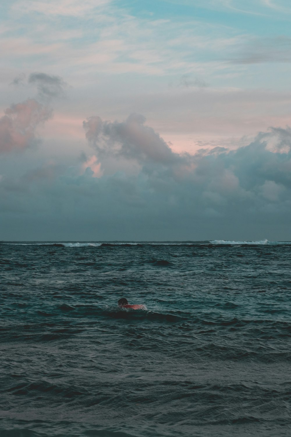 person swimming on body of water