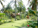 Garden bungalow surrounded by vibrant tropical plants and flowers.