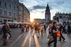 people walking on street near concrete buildings