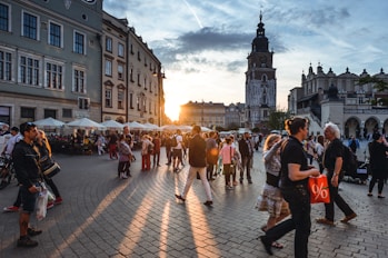 people walking on street near concrete buildings