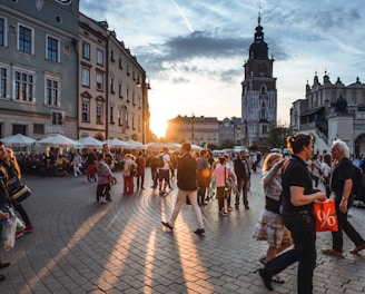 people walking on street near concrete buildings