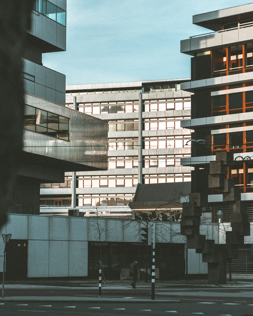 person walking on road near high rise buildings at daytime