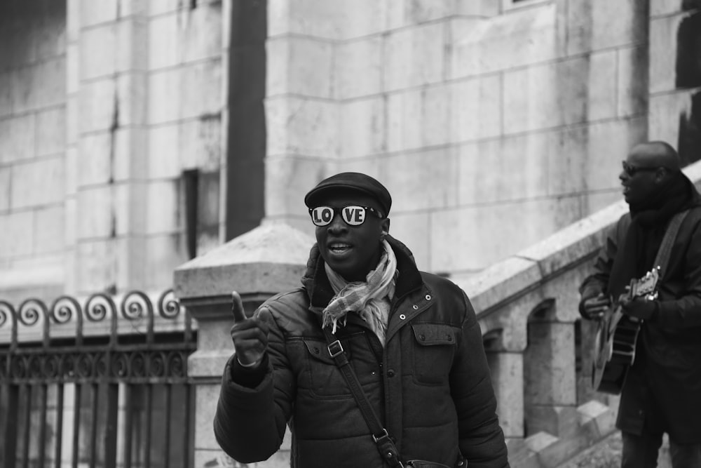 man pointing his hand near building