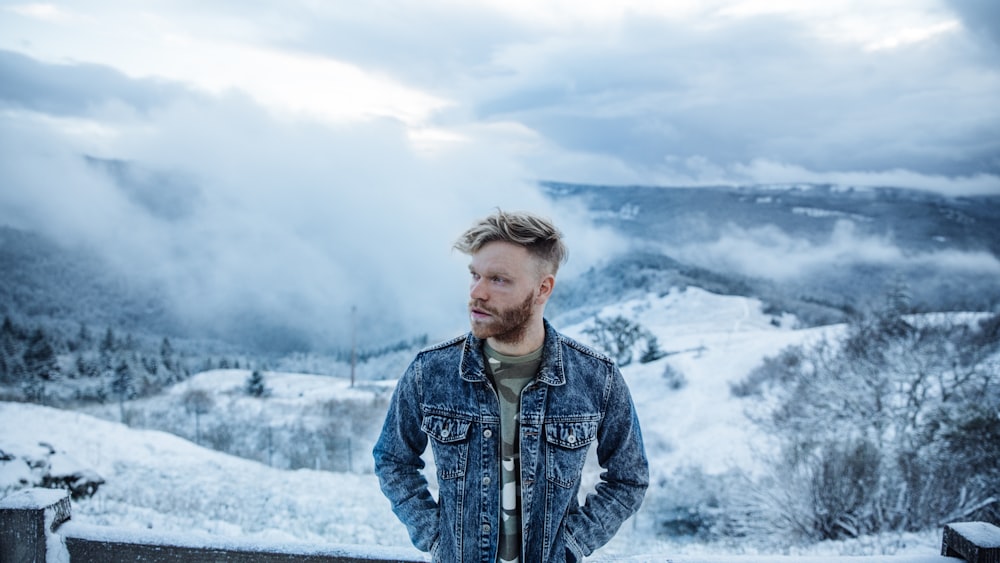 man standing in front of snow mountain