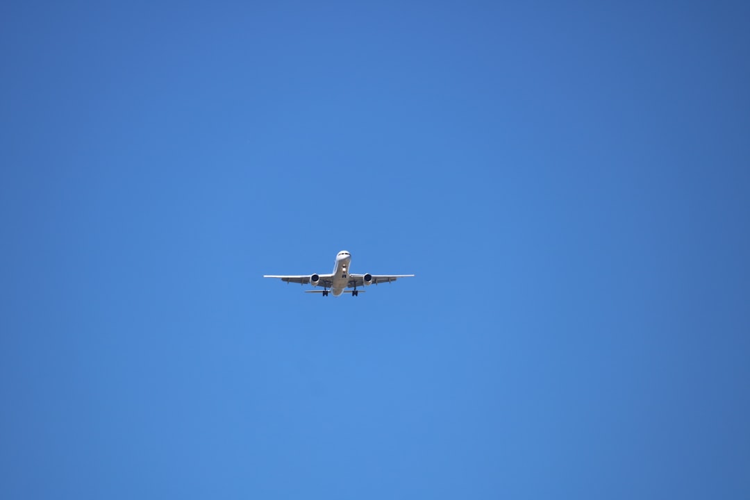 low angle photography of gray airplane under blue sky at daytime, Airplane Alajuela