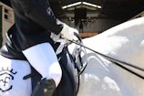 A rider gracefully guiding a horse through a dressage routine.