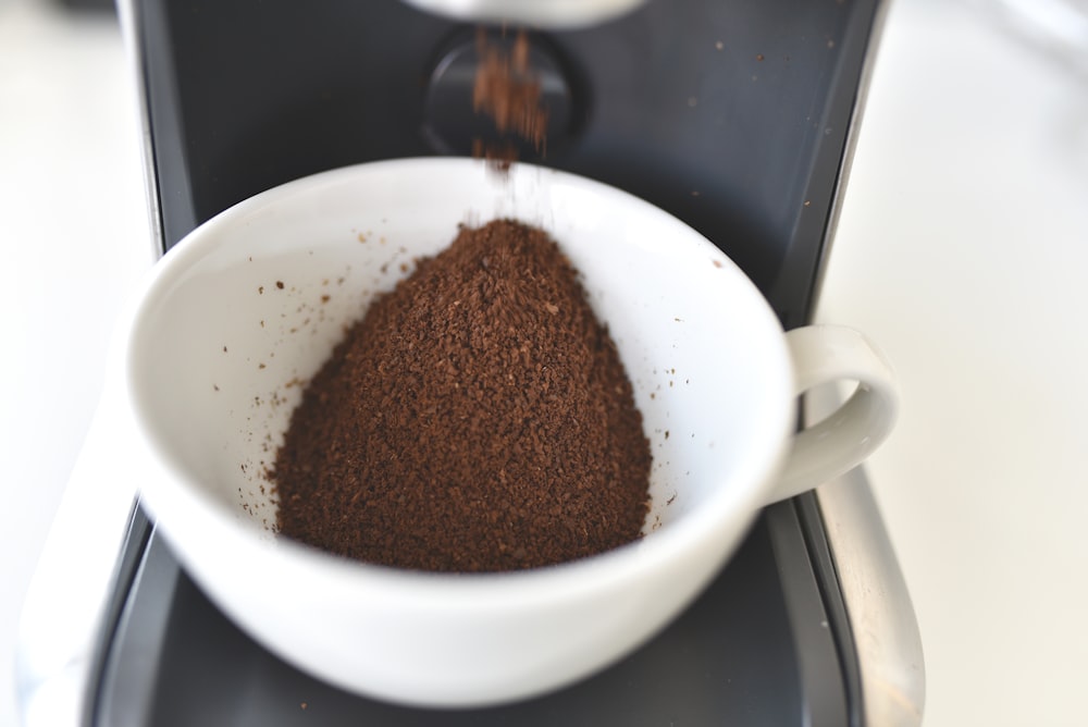 white ceramic cup with brown powder inside