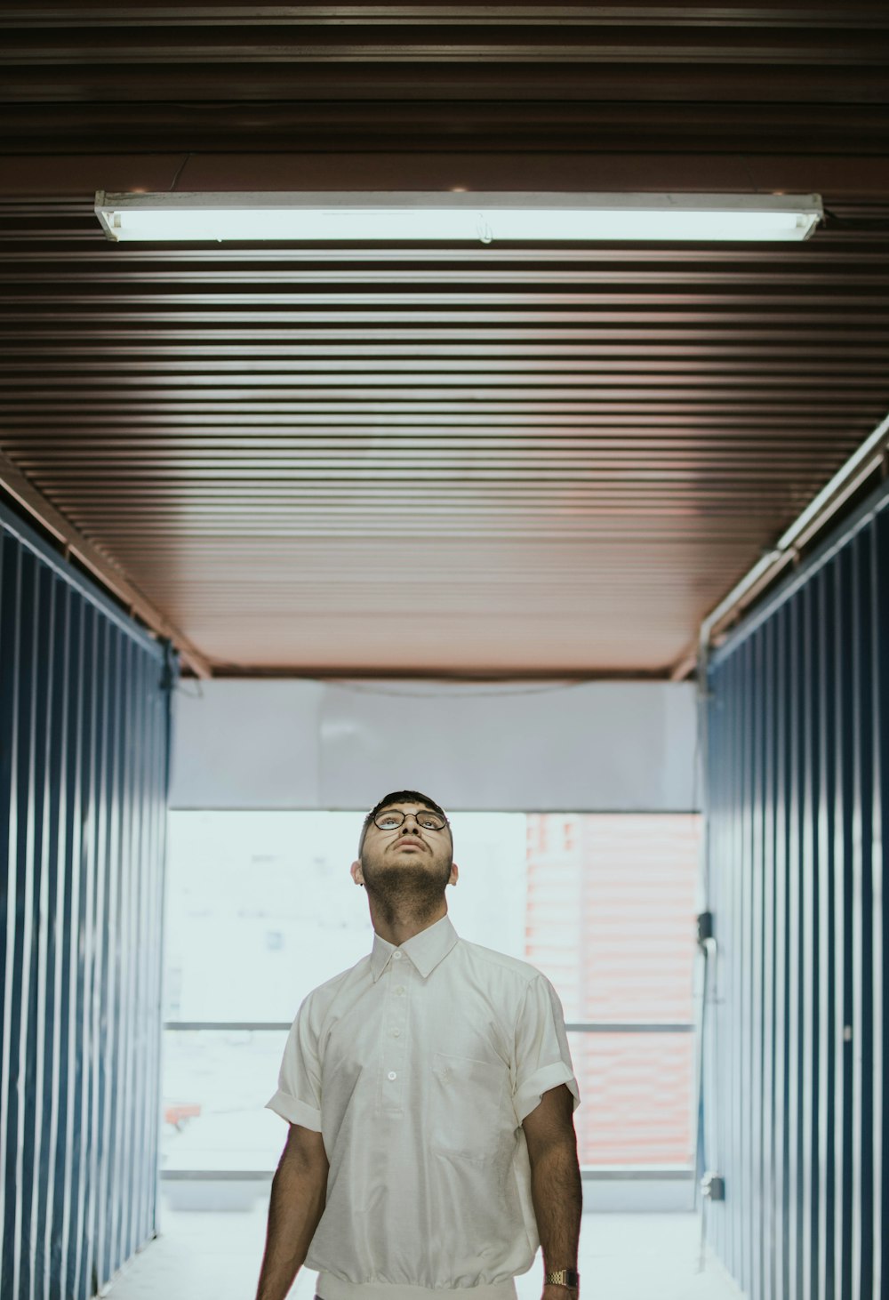 man staring above on brown ceiling