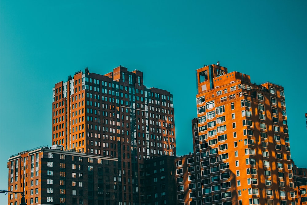 low angle photo of orange high rise building