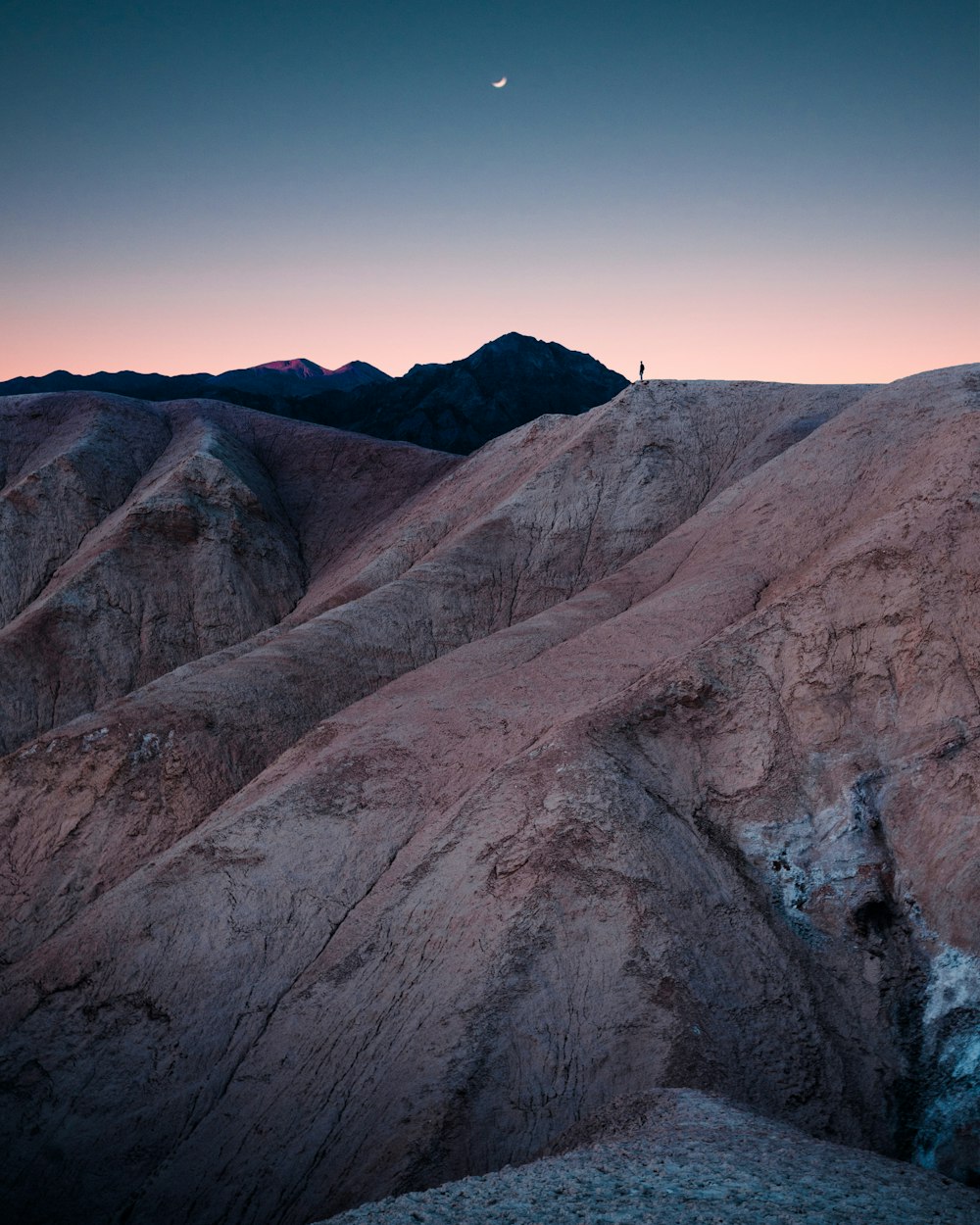 man standing on mountain during daytime