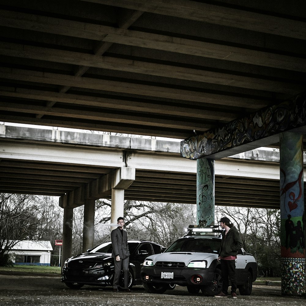 two man standing near cars