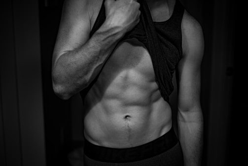 Before and after photos of a man showing muscle gain progress over weeks.