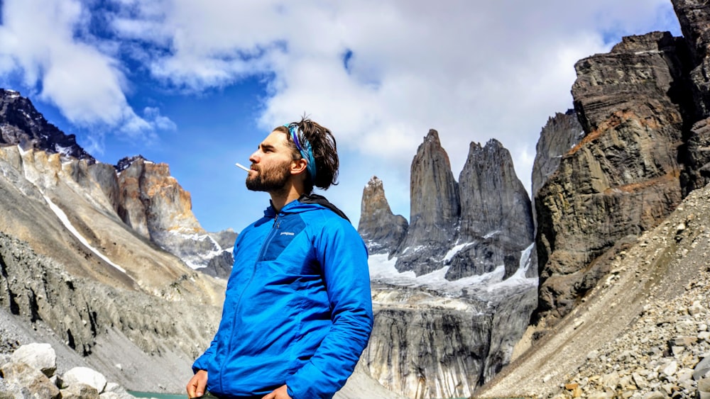 a man standing in front of a mountain range