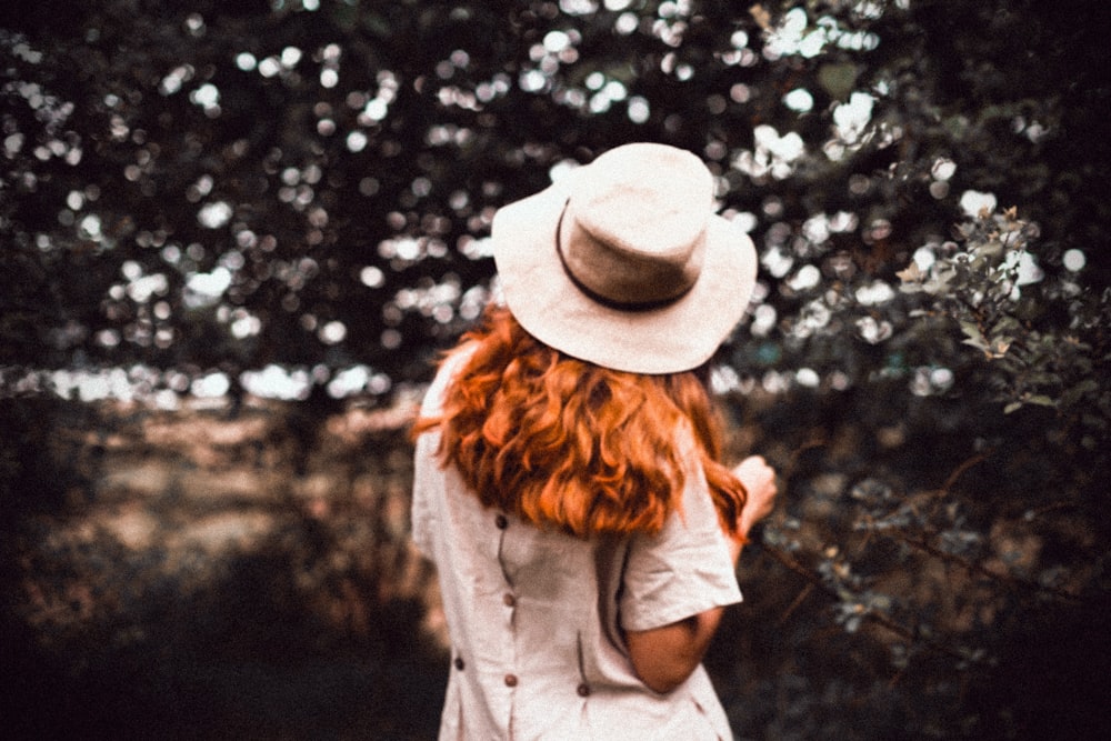 woman standing near green leafed tree