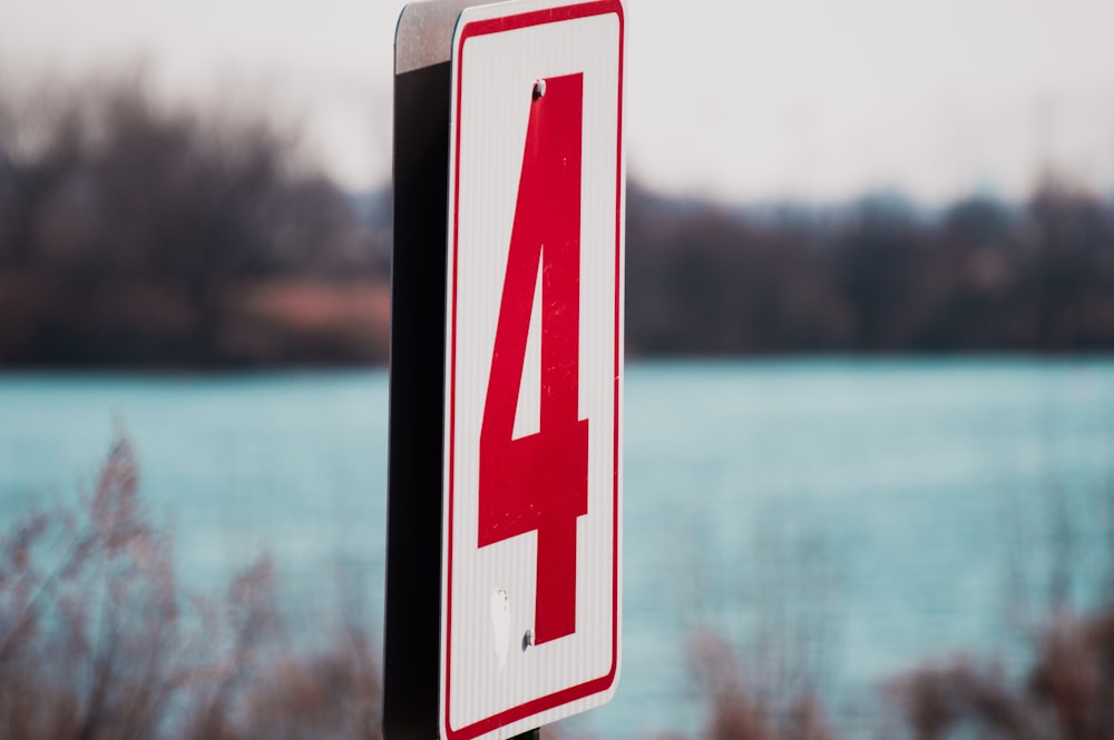 white and red number 4 signage in shallow focus photography
