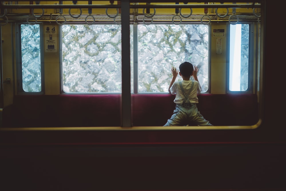 boy leaning on glass window