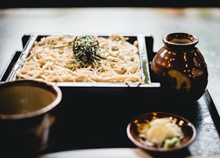 white pasta on black wooden plate