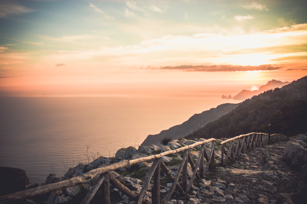 brown wooden fence near cliff