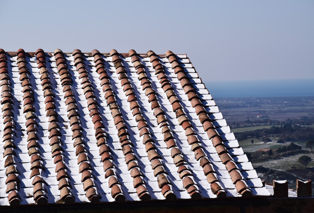 a tiled roof with a view of a valley in the distance
