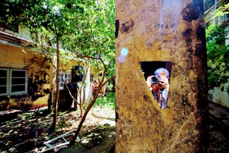 Professional photographer taking pictures of a luxury villa's garden during golden hour.