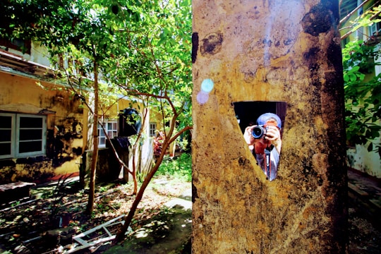 Professional photographer taking pictures of a luxury villa's garden during golden hour.