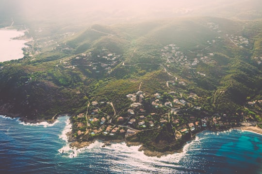 bird's eye view photo of green mountain peak near body of water in Corse France