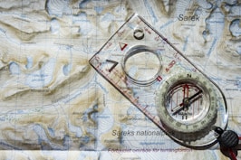 clear and white compass with ruler on map illustration