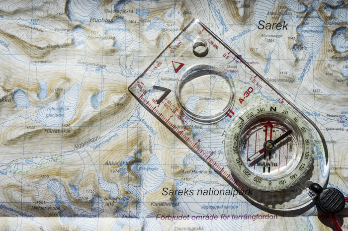 Compass resting on a topographic map